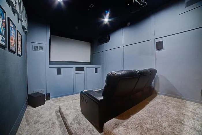 Theatre space has a projector and large screen for your viewing pleasure.