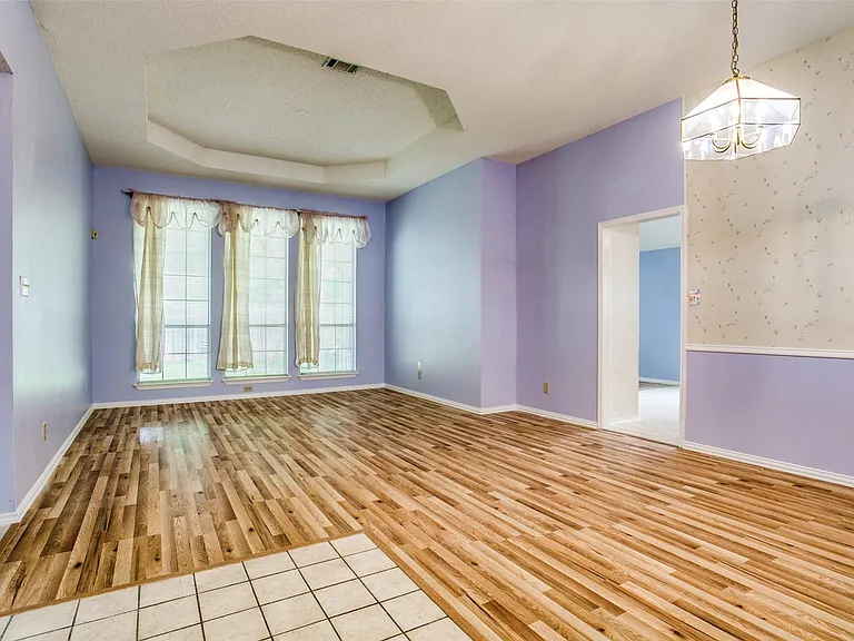 And another view of the very spacious living area. Attractive ceilings, 3 large windows and access to the kitchen and beds to the left. Room closer to entrance could be used as a dining area.