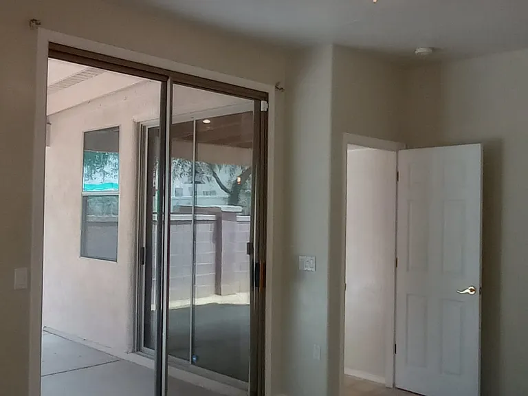 Access to the back patio with slider in the primary bedroom.