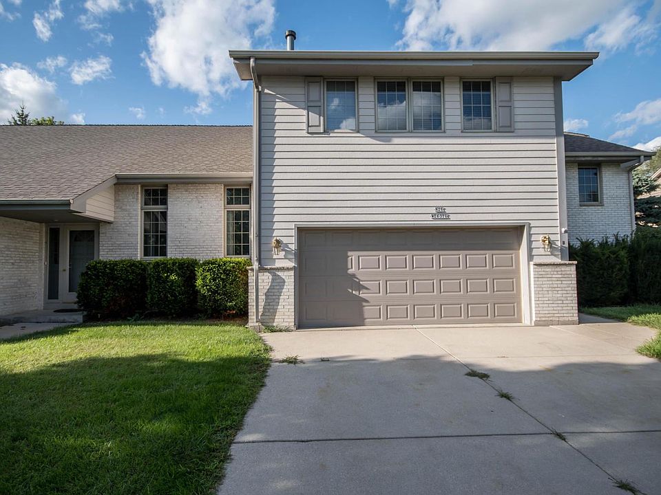 Exterior with private drive and 2 care attached garage