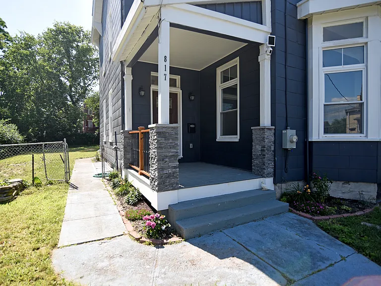 Amazing porch with wrought iron railings, distinctive mailbox and executive front door with unique hardware.