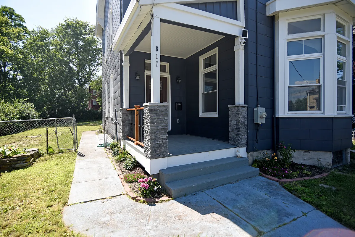 Amazing porch with wrought iron railings, distinctive mailbox and executive front door with unique hardware. - 817 Considine Ave