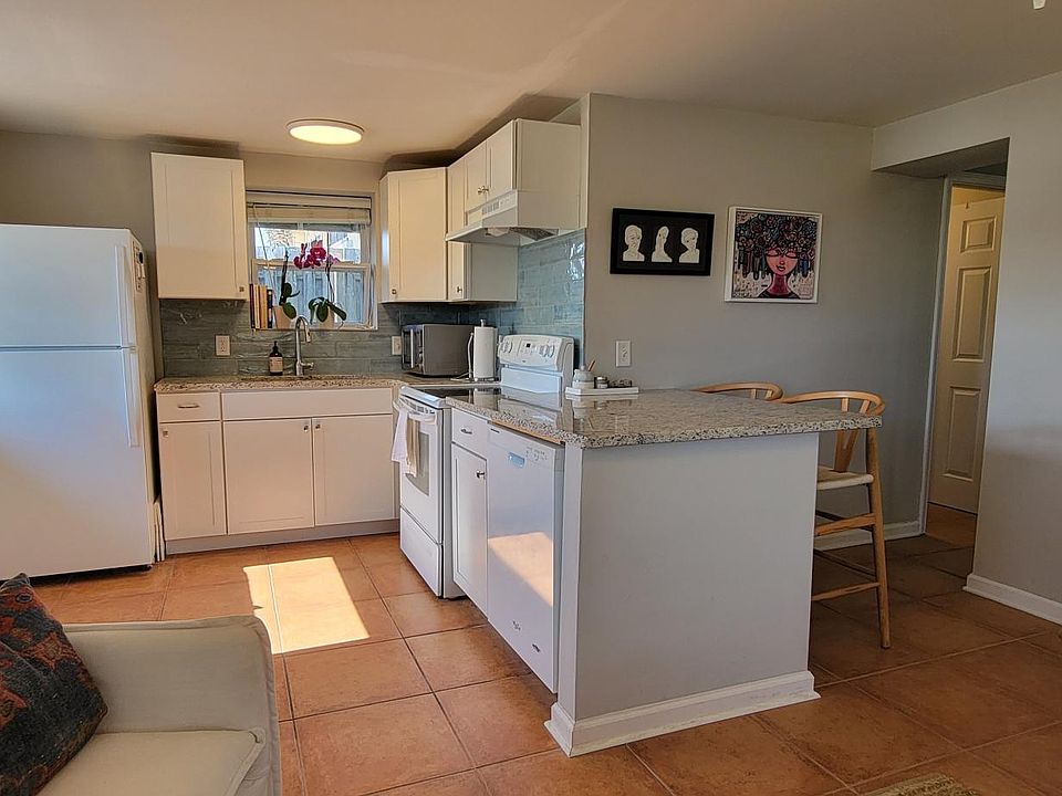 Kitchen has granite countertops with a breakfast bar with room for 2 stools.