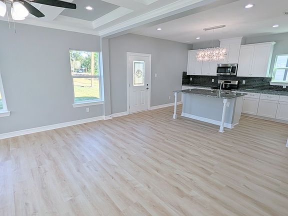 Open concept living, dining, and kitchen spaces make it easy to gather with family and friends.