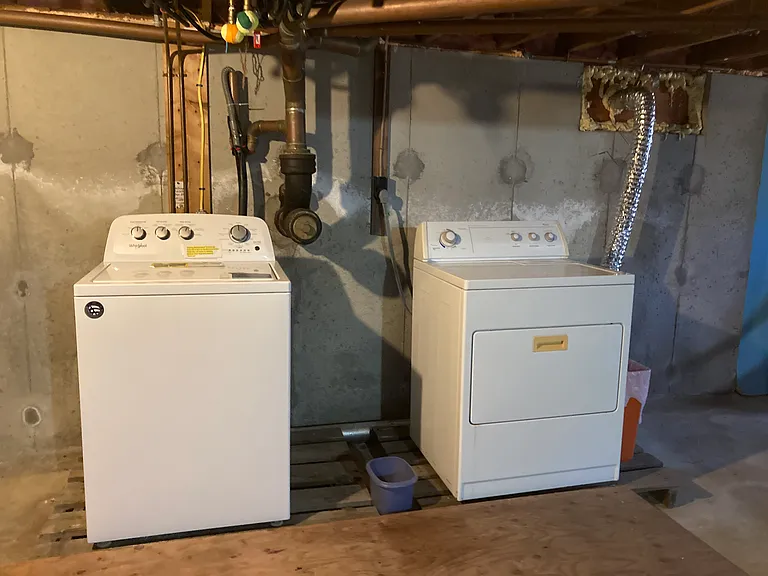 Laundry in basement off small hall/kitchen area.