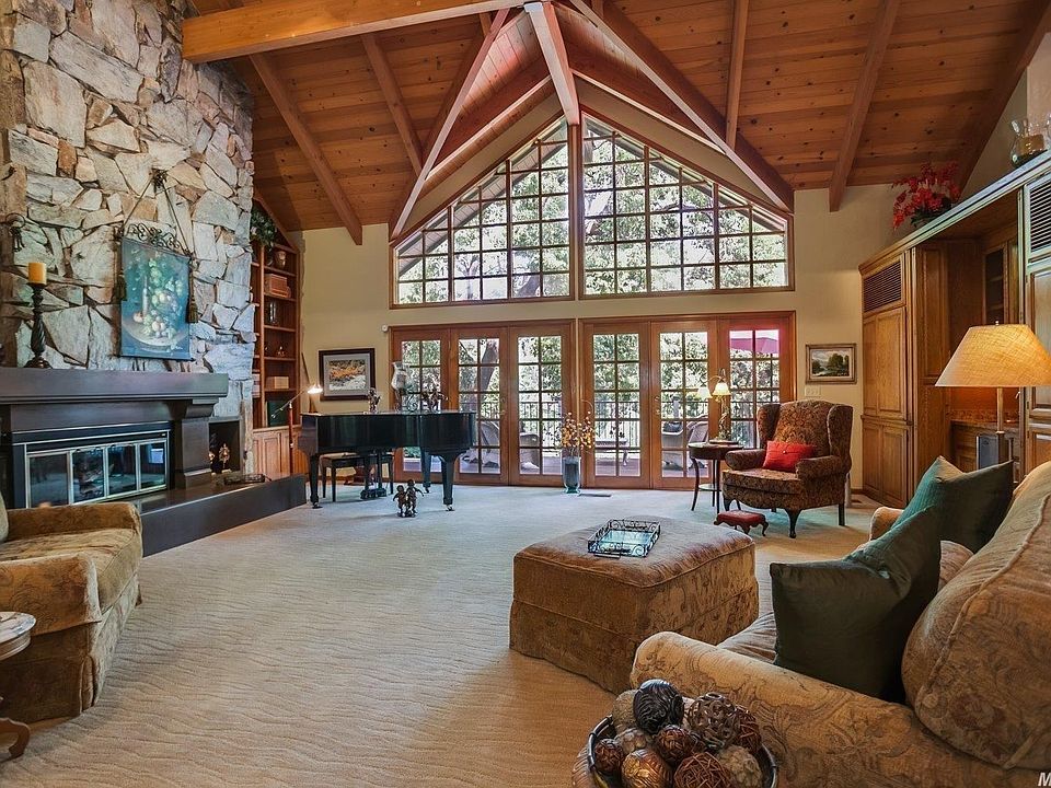 Architecturally exquisite, this Brook Way custom home is a treasure! From the soaring ceilings and floor to ceiling fireplace, to the gorgeous grounds, this home shows attention to details. The first level includes over 1400 square feet of storage rooms n