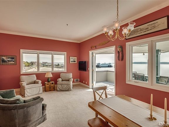 Living room looks east into town and Ferry, South to islands, and west to mountains. French door leads to wondrous deck.