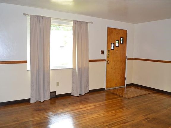 The living room entry is accented with a parquet wooden floor.