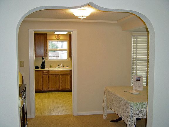 Original arched entryway into dining area.