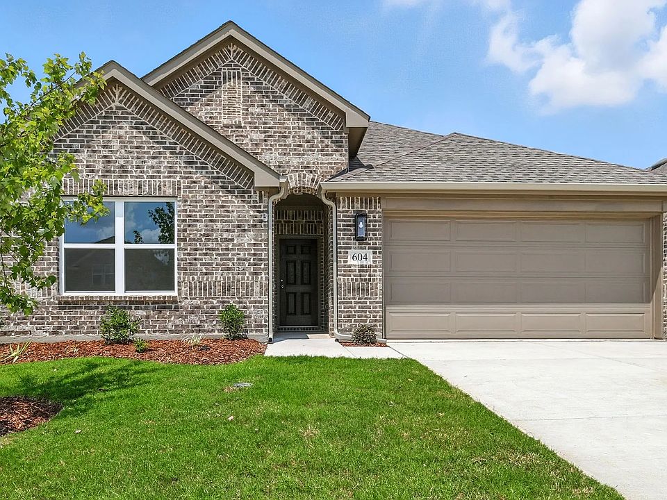 Elegant single-story brick facade with exquisite gable detail and modern garage in Simpson Crossing.
