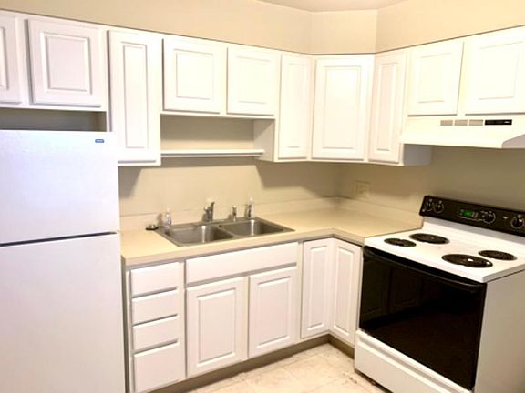 Full kitchen with range, oven, refrigerator, and sink disposal, as well as newer cabinets. Large window lets in plenty of natural light.