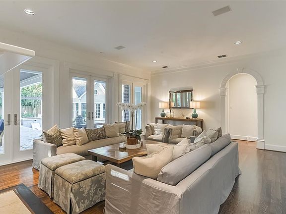 The family room is located adjacent to the kitchen and overlooks the pool and outdoor living areas. Featuring newly refinished hardwood floors, extensive mill-work and three sets of French Doors.