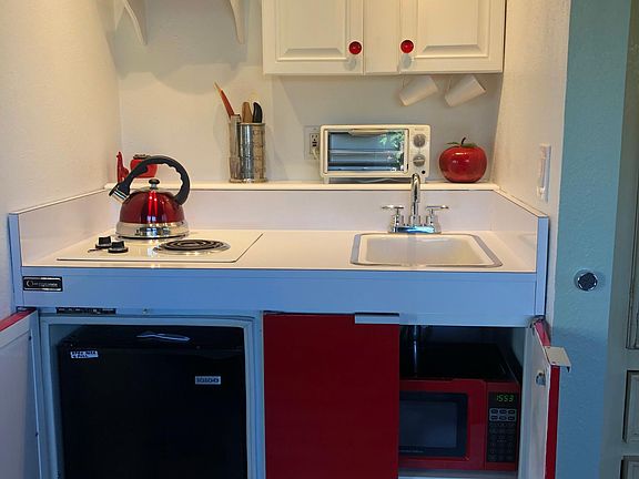 Mini kitchen with stove, microwave and sink
