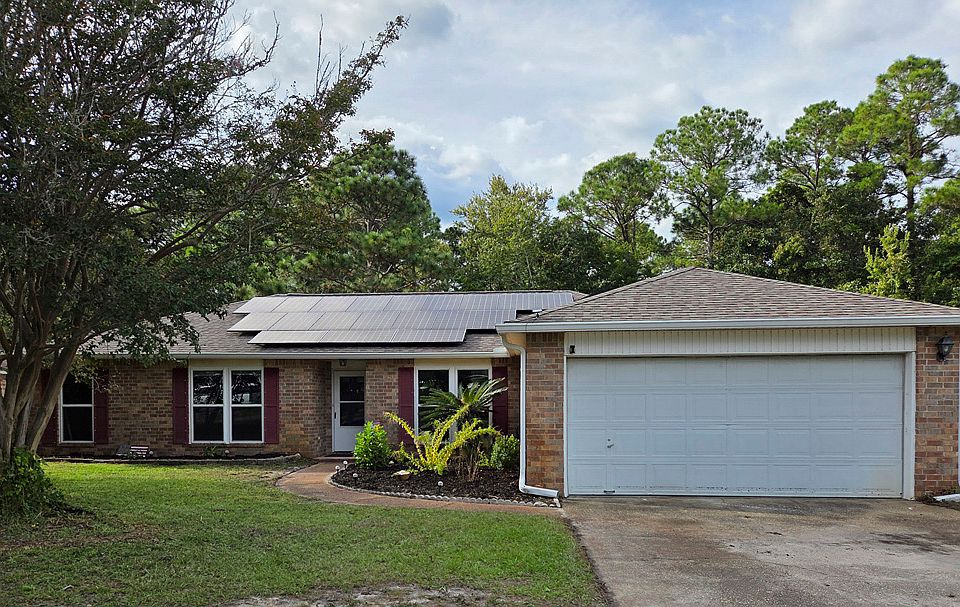 Front of house with two car garage. Also, attached solar panels provide efficiency and lower utility bills!