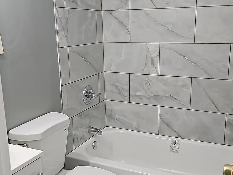 Brand new bathroom with new toilet, bathtub, vanity, floor, shower and shower surround