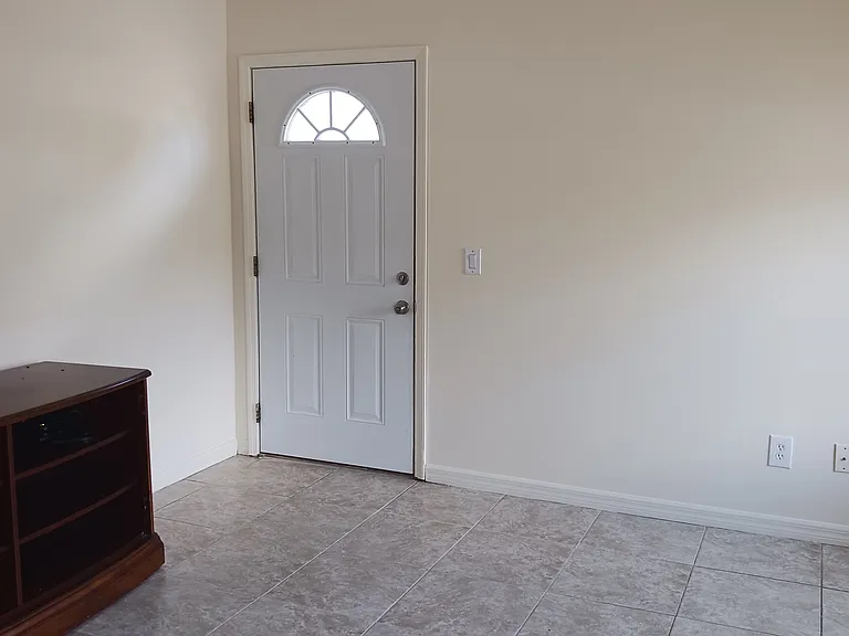 Living room with side entrance leading to your own private parking spot.