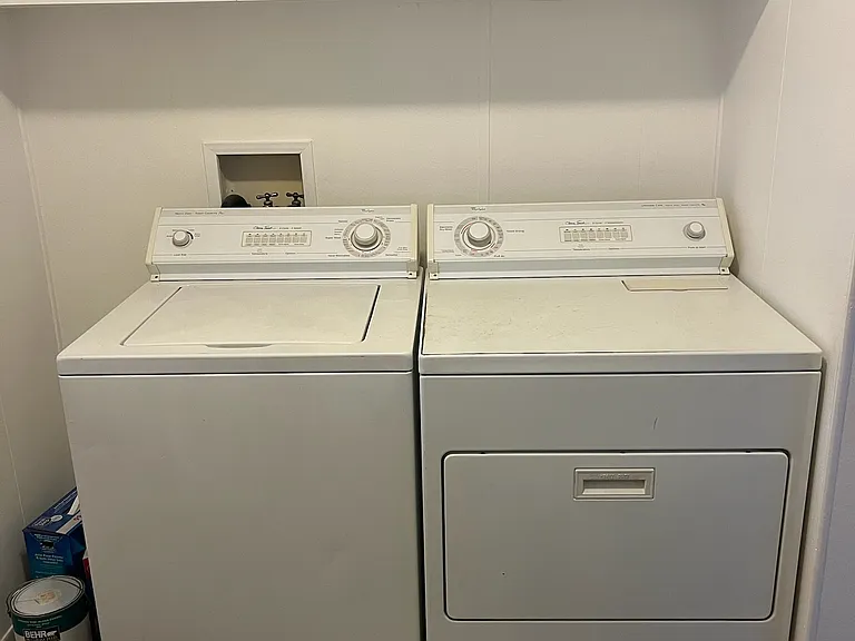 Laundryroom has lots of cupboards and an additional closet great for storage or mops, brooms and vaccuums.