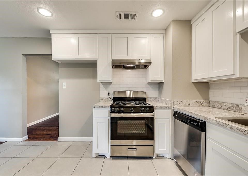 Gorgeous updated kitchen with new white cabinets, Stainless gas stove & dishwasher, updated Subway tile backsplash and countertops.