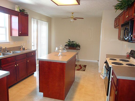 Spacious eat-in Kitchen has cherry cabinets, island