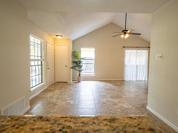 small closet at front door, sliding glass door leads to covered deck
