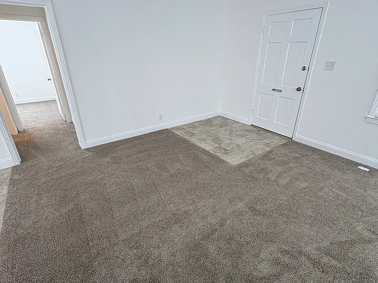 Photo taken from fireplace area towards front door.