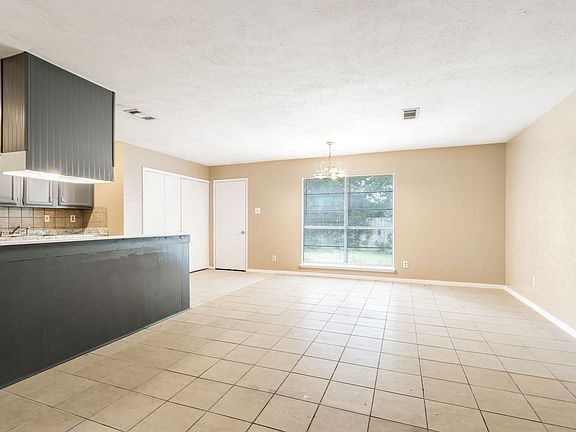 The spacious living room flows seamlessly into the kitchen, creating the perfect space for entertaining!