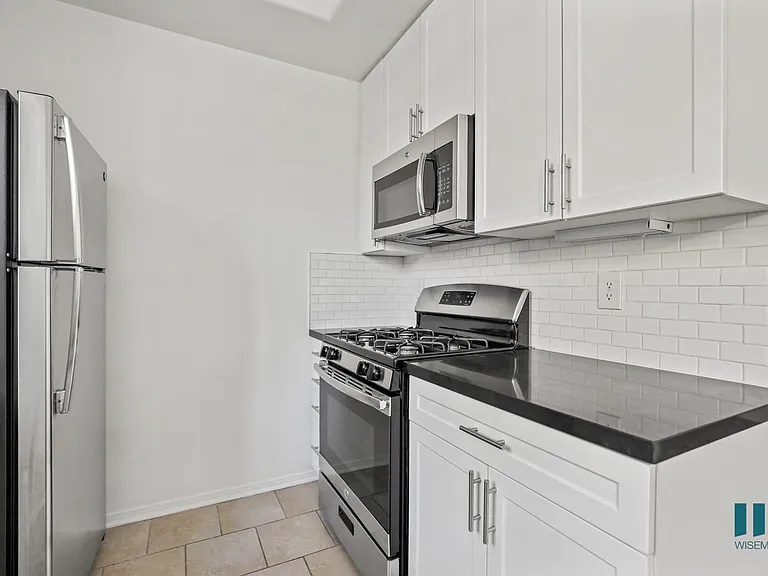 Kitchen with Stainless-Steel Refrigerator, Stove, and Microwave Oven