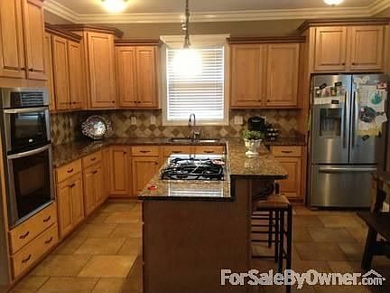 Large Kitchen with Granite Counter tops
						:
						stone backsplash, tile floors, SS appliances and granite desk, & custom cabinets