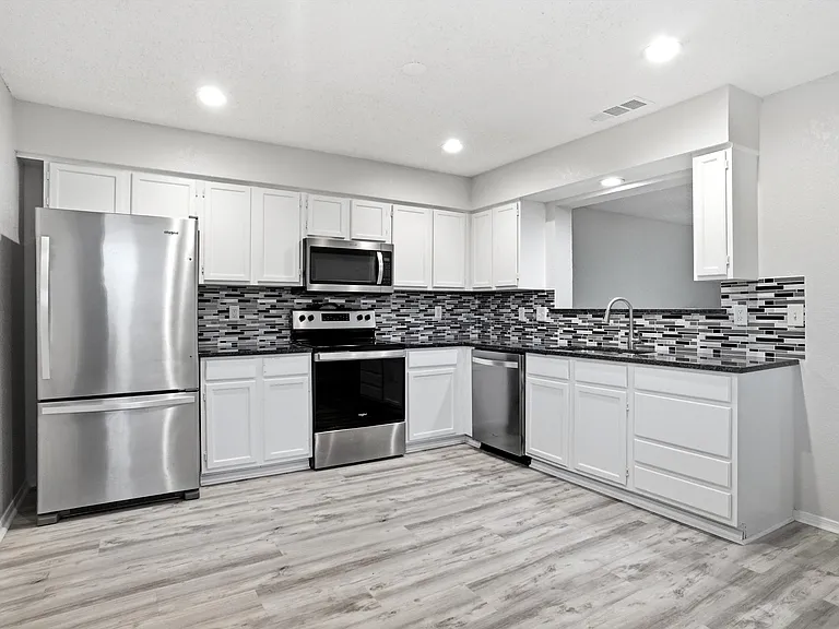 Kitchen with room for dining table. Refrigerator will stay.