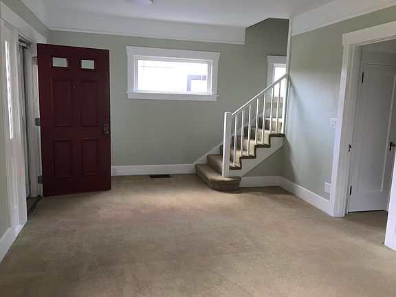 Inside the front door off classic covered front porch. Stairway to upper level.