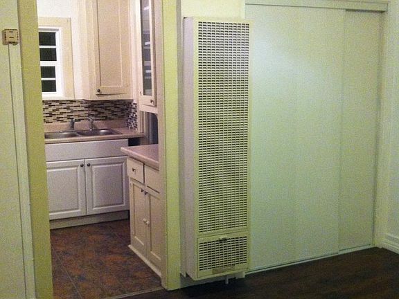 Living room closet (extra storage) with wall heater