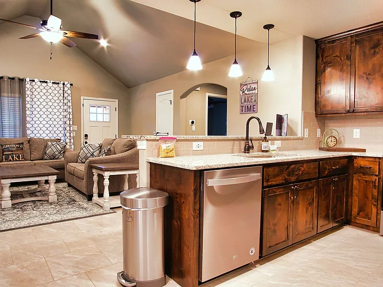 The kitchen offers stainless steel appliances, a breakfast bar with seating for 3. Refrigerator included.