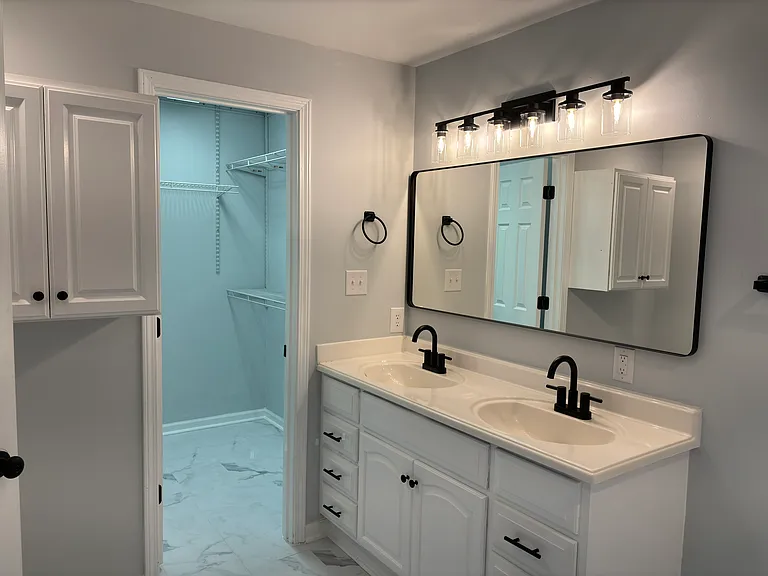 Master bathroom with view of walkin closet