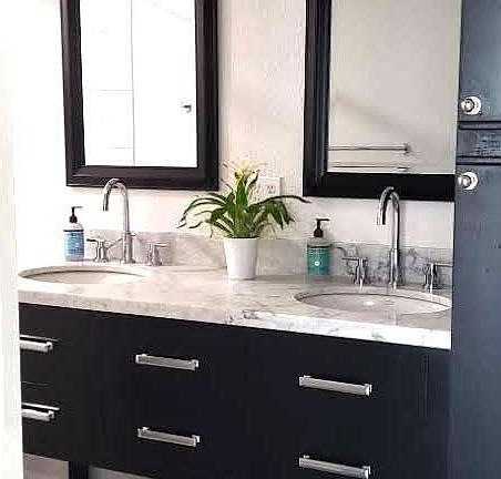 Remodeled bathroom complete with Carerra marble top vanity with abundant storage.