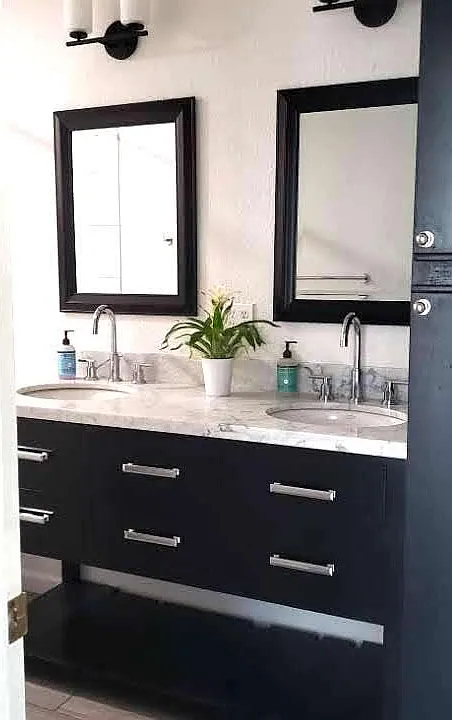 Remodeled bathroom complete with Carerra marble top vanity with abundant storage.