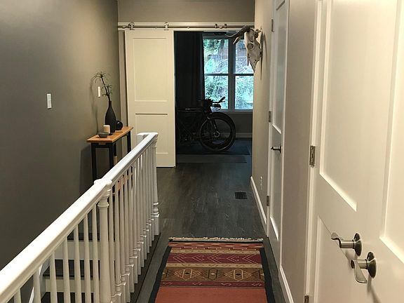 Upper-level Hallway with view into 3rd Bedroom