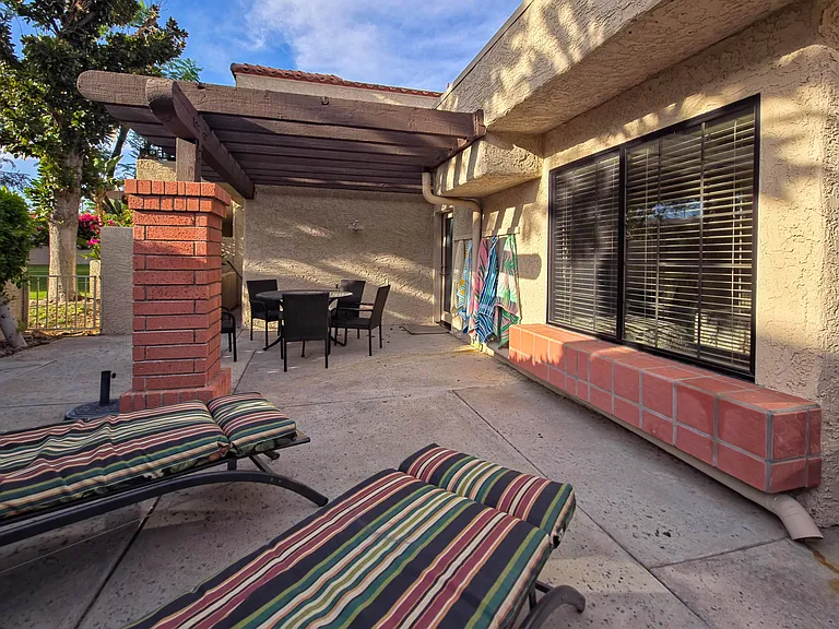 Back patio showing lounge seating and table with chairs.