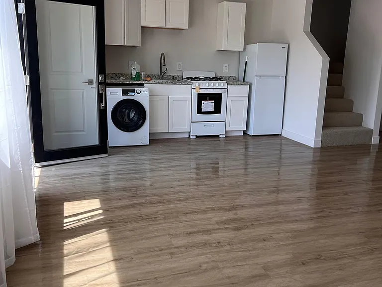 Open Kitchen with Stove and refrigerator. Inside laundry with washer and dryer included.