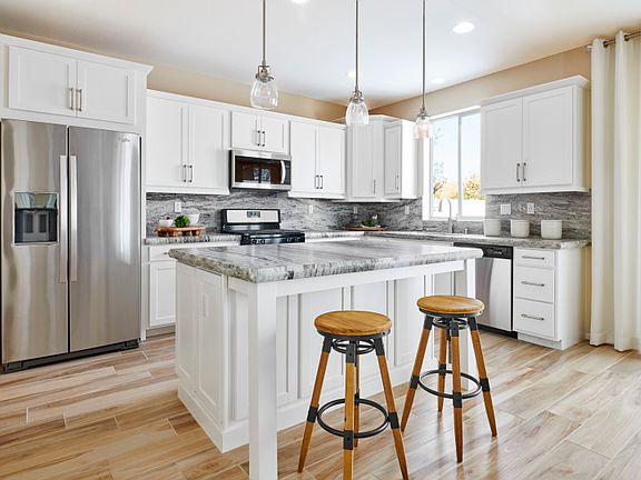 Enjoy your coffee each morning at the kitchen island with a built-in bar.