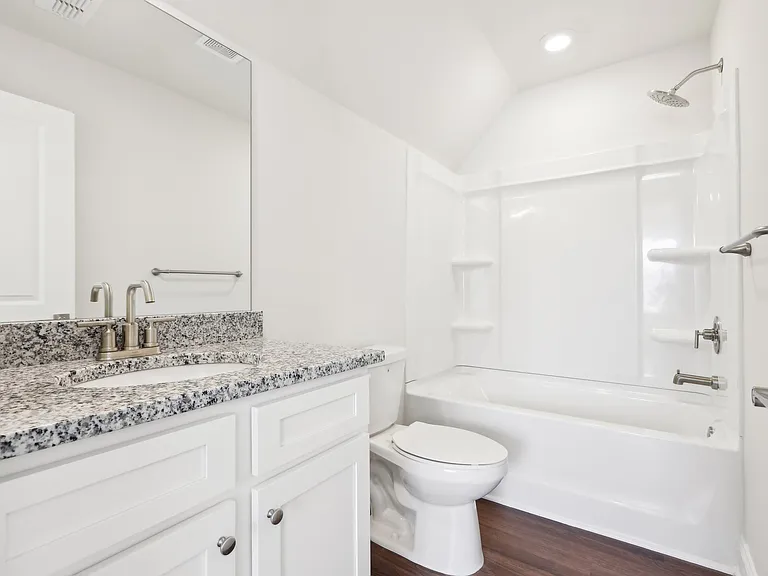 Secondary bathroom with tub shower and single vanity.
