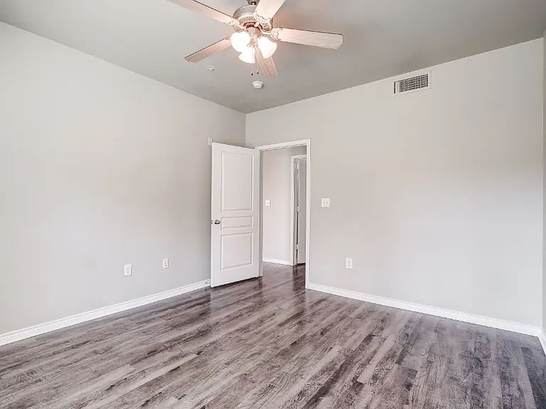 Bedroom with wood-style flooring, ceiling fan, and cable ready