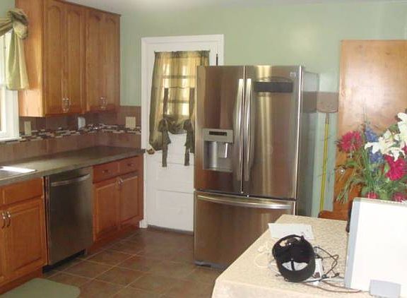 Another view of the kitchen. Doorway to the left opens to a small sunroom area. 