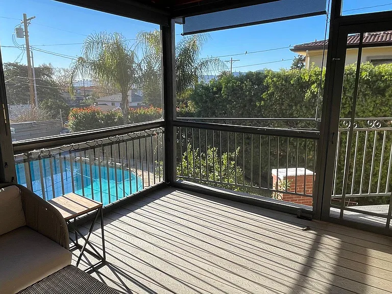 Screened in patio from kitchen French doors, overlooks backyard, pool and mountains.