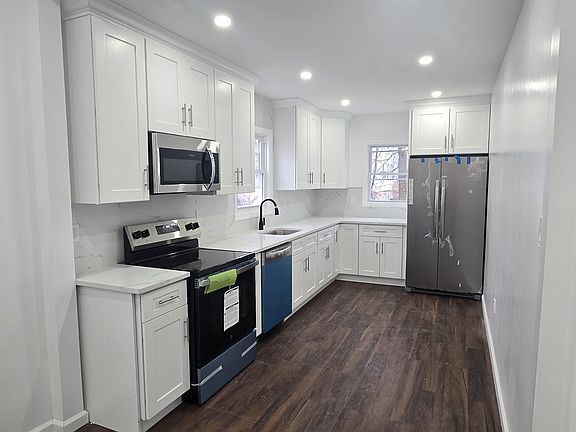 Renovated kitchen with stainless steel appliances including fridge, stove, micowave and dishwasher.