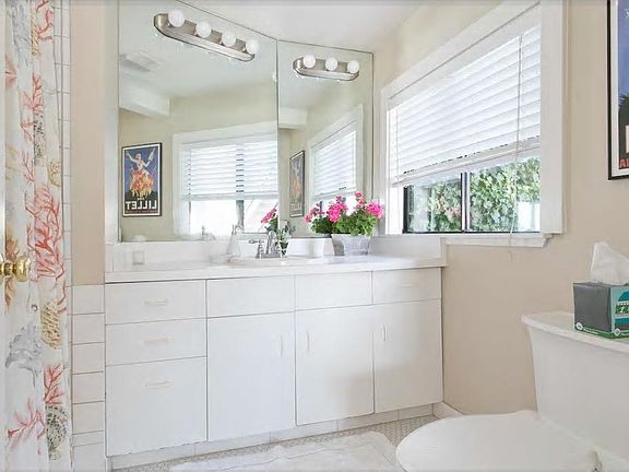 Bathroom with full tub and shower on the left.