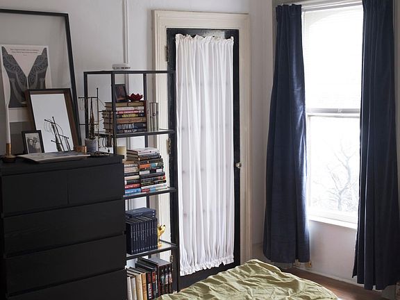 Bedroom looking toward bathroom door. Windows face north.