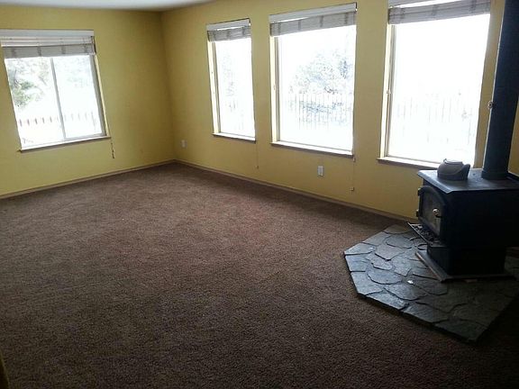 Living Area with wood stove. Repainted light grey.