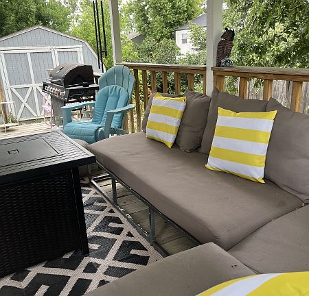 Covered deck. Large shed in background with electricity and lights.