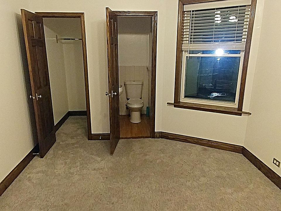 One of the THREE bedrooms. Unit has 1.5 baths. That is the half bath in the background. The ONLY carpeted room in the apartment.