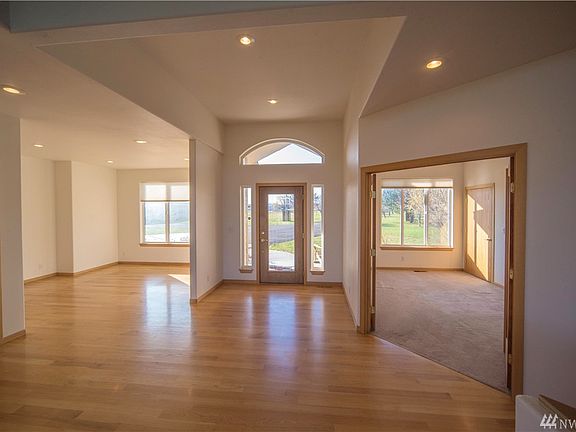 View from living room. Looking toward front door with formal dining area on the left, 4th bedroom/office with French doors to the right.